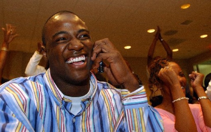  Troy defensive end DeMarcus Ware, seated next to fiancee Taniqua Smith, reacts to news that...