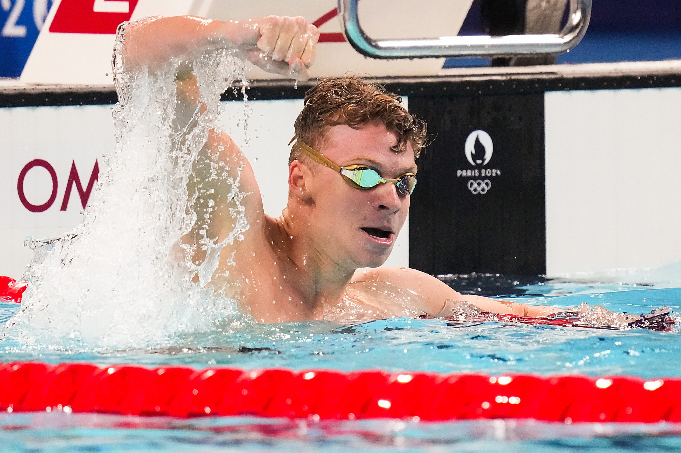 Fans cheer Leon Marchand of France celebrates after winning the men’s 200-meter breaststroke...