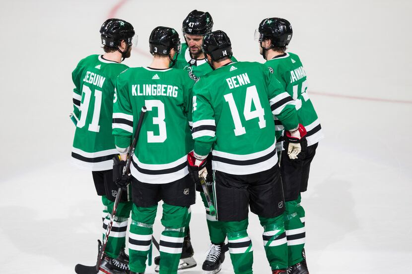 FILE - Stars players celebrate a goal scored by left wing Jamie Benn (14) during the second...