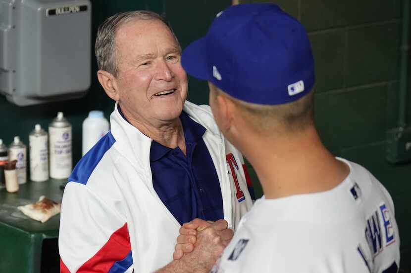 Former President George W. Bush shook hands with Texas Rangers first baseman Nathaniel Lowe...
