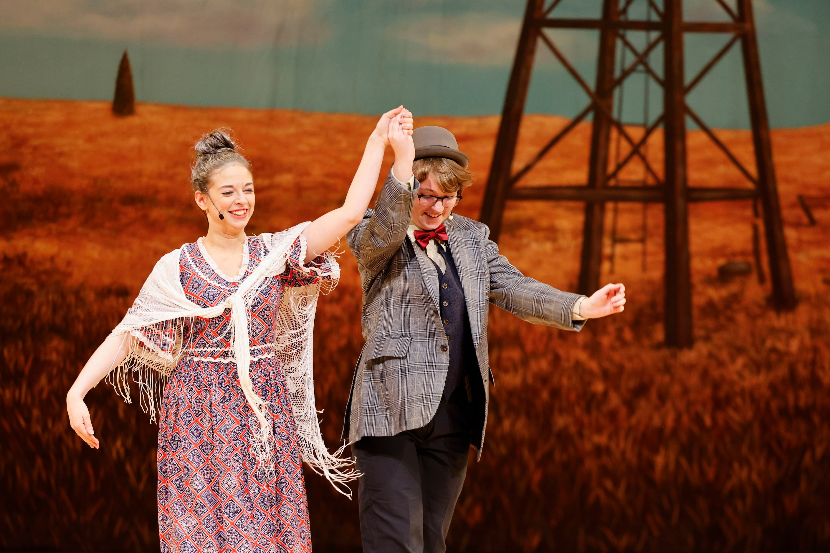 Cast members Kiersten Harston as Aunt Eller, and Max Hightower as Ali Hakim take a bow after...