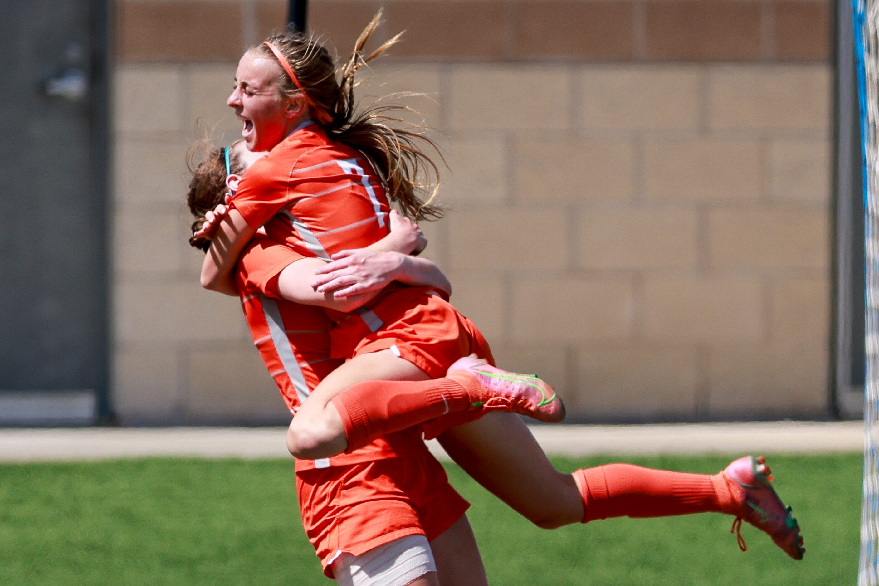 Celina midfielder Lexi Tuite (7) leaps into the arms of Celina forward Taylor Zdrojewski...