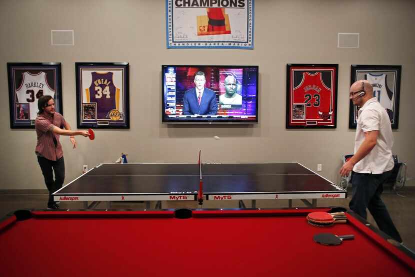 
In a file photo, sales representativesplay ping pong in the break room of a Plano security...