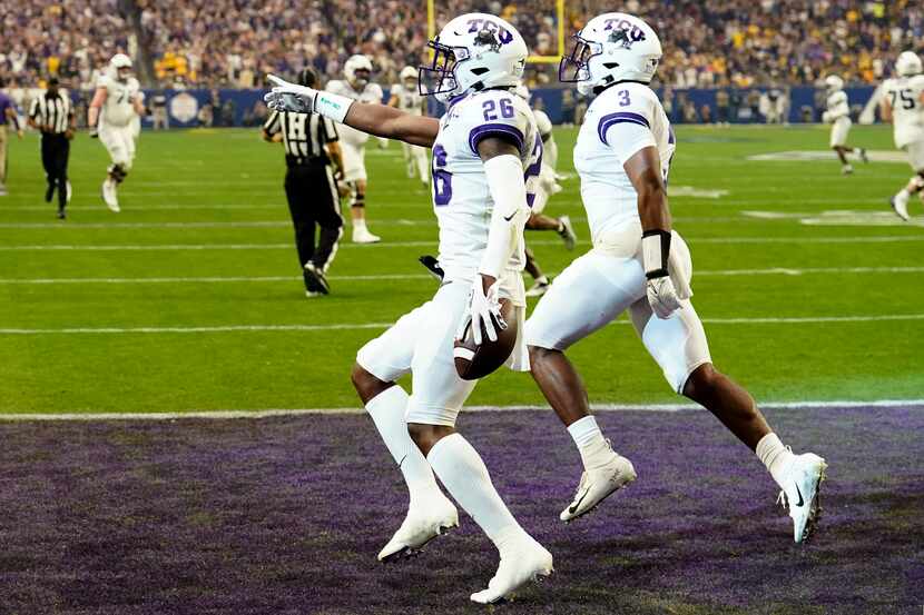 TCU safety Bud Clark (26) celebrate his interception for a touchdown against Michigan during...