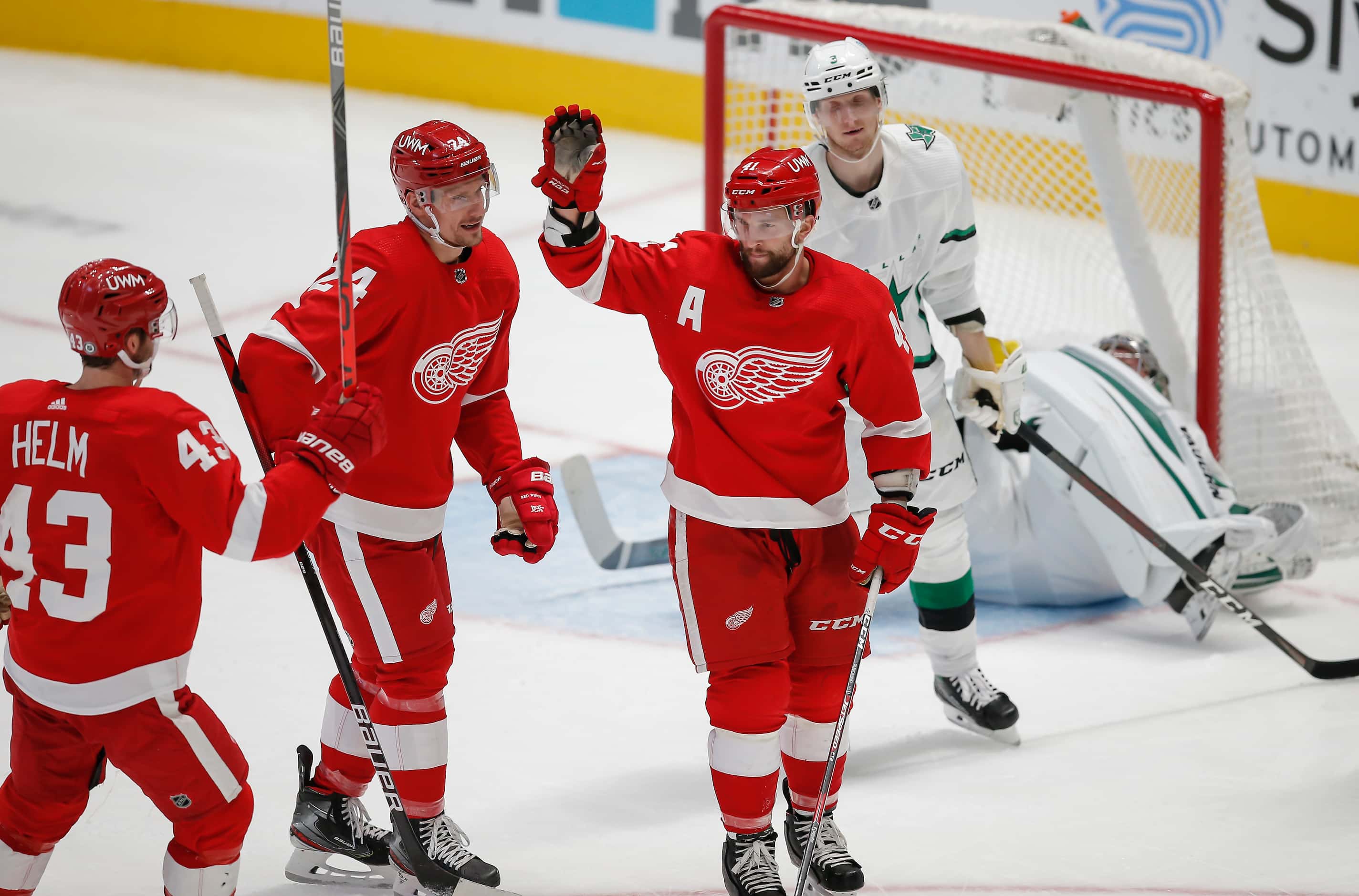 Detroit Red Wings forward Luke Glendening, third from left, is congratulated by teammates...