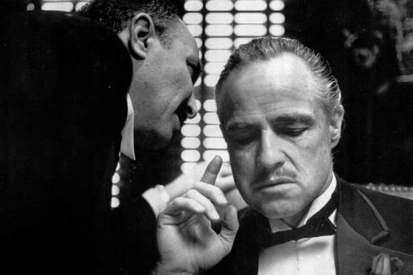 This photo provided by Paramount Pictures shows Marlon Brando, right, as Don Corleone, in a...
