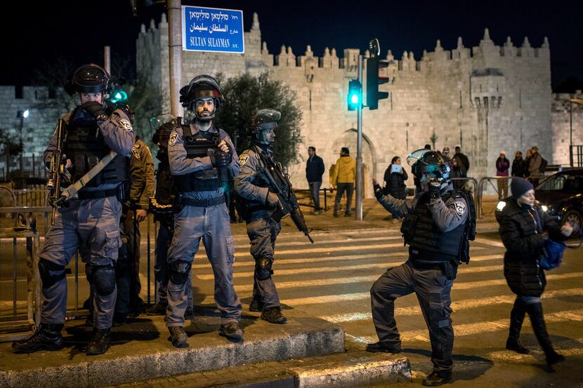 Israeli Police officers stand watch outside the Damascus Gate in the Old City on December 7,...