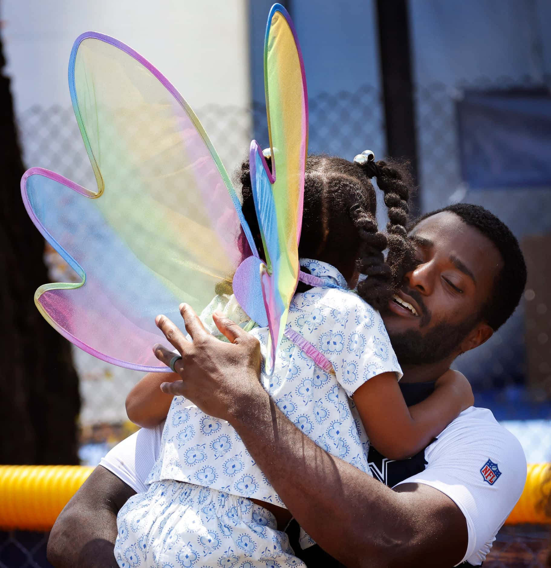 Dallas Cowboys cornerback Jourdan Lewis hugs his daughter Riley mom Arille mom at training...