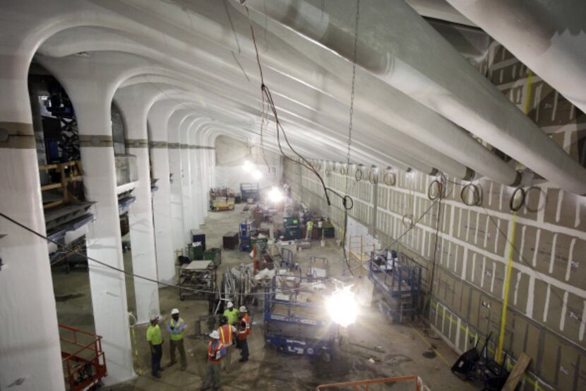 Construction continues beneath the arched columns of the East-West Corridor at the World...