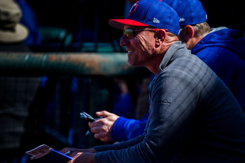 Texas Rangers manager Jeff Banister (28) smiles as he watches the second inning of a spring...
