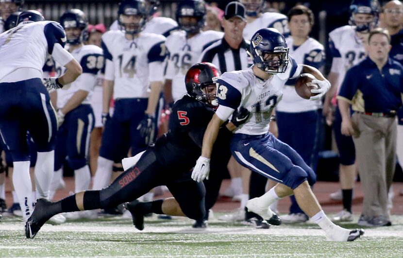 Irving MacArthur’s Darius Kirksey (5) tackles Jesuit’s Max Loughborough (13) during game...