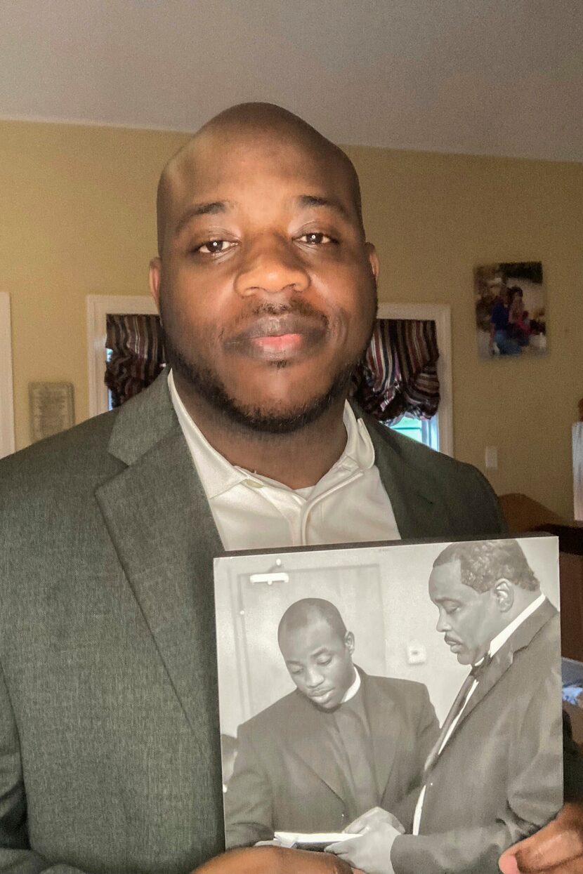 Darrell Dixon holds a photo of him and his dad, Darrell Dixon Sr.