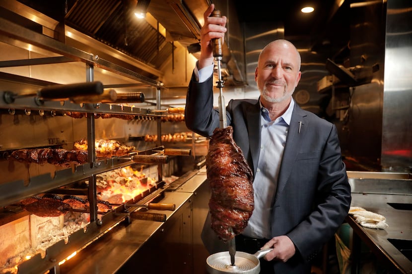 Salim Asrawi, founder and owner of Texas de Brazil, with a skewer of flank steak at the...