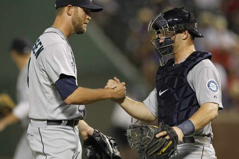 Seattle Mariners relief pitcher Tom Wilhelmsen (54) and catcher Mike Zunino (3) celebrate...