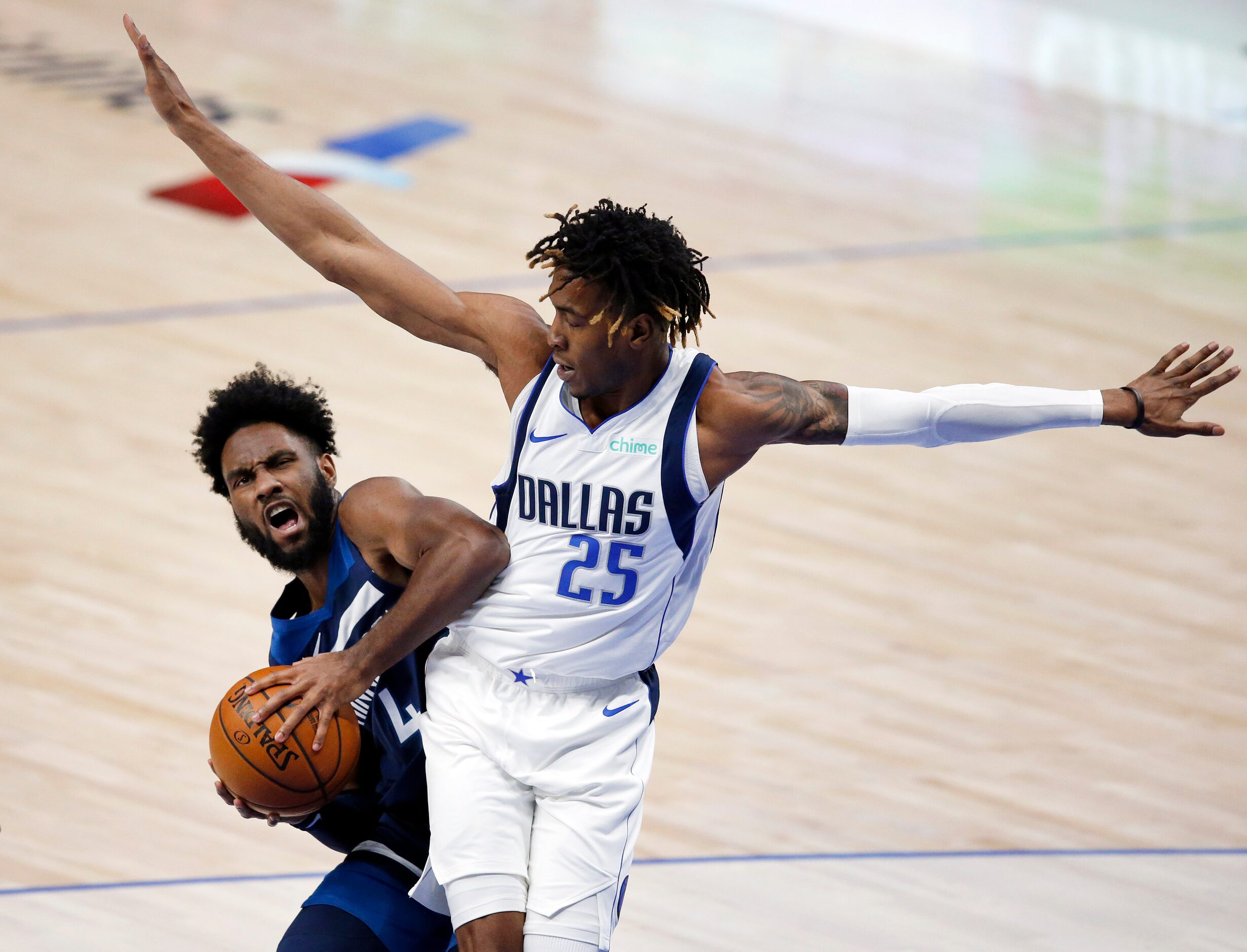 Dallas Mavericks forward Wes Iwundu (25) tightly covers Minnesota Timberwolves guard Jaylen...