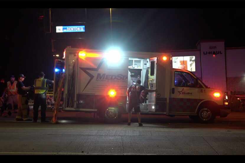 Paramedics prepare to transport a woman who was injured in a hit-and-run Wednesday morning...