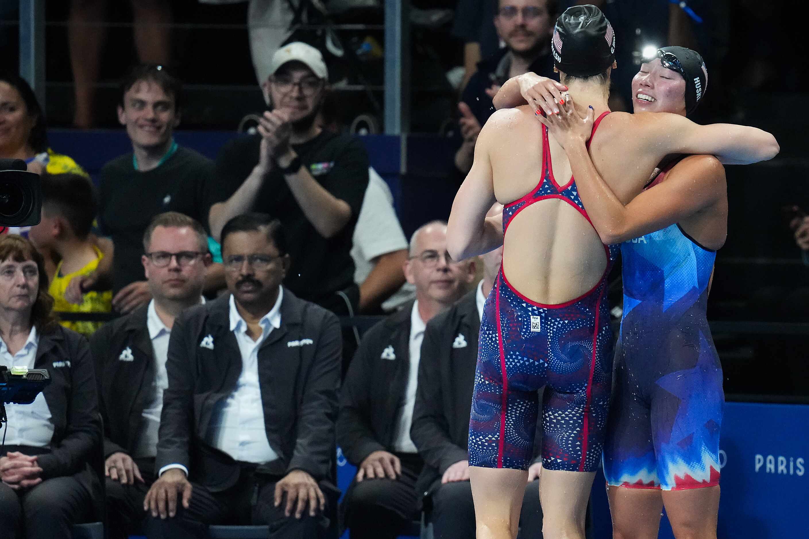 Torri Huske (facing) of the United States celebrates with teammate Gretchen Walsh after...