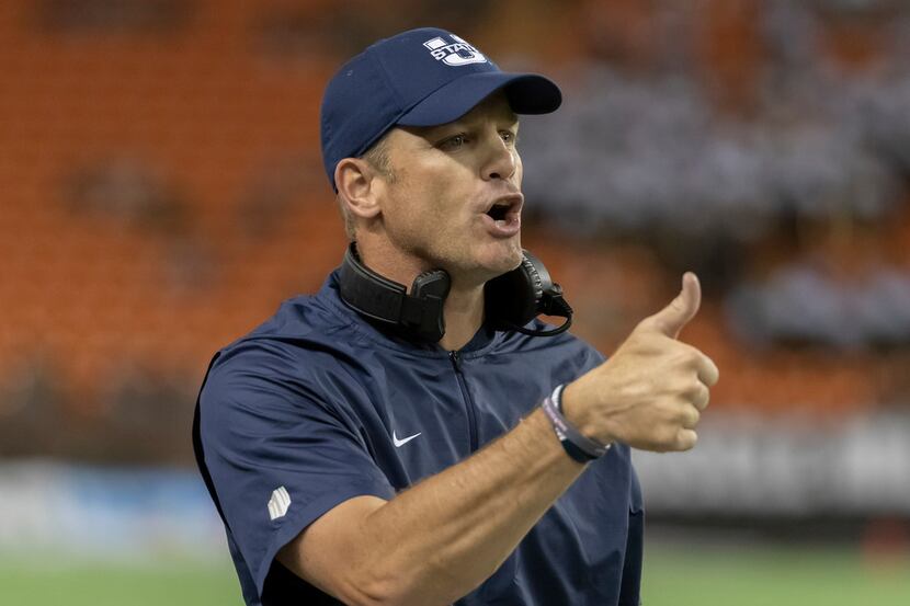 Utah State head coach Matt Wells gives the thumbs up to the game officials in the first half...