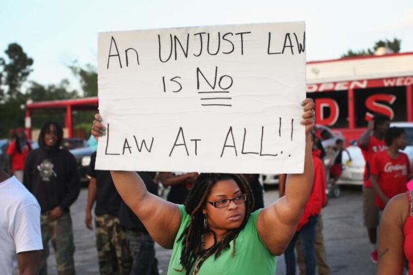 
Demonstrators protest the killing of 18-year-old Michael Brown who was shot by police...