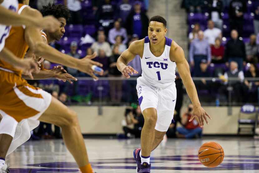 TCU Horned Frogs guard Desmond Bane (1) drives the ball down the court during the first half...