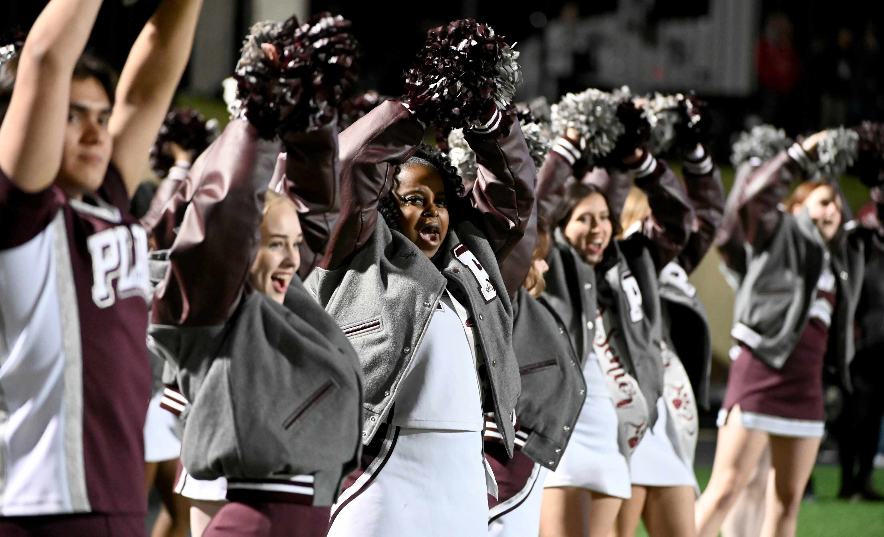 Plano cheerleaders perform in the first half of a high school football game between Flower...