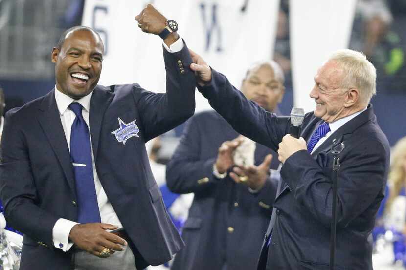 Former Cowboys safety Darren Woodson shows off his commemorative watch as he talks with...