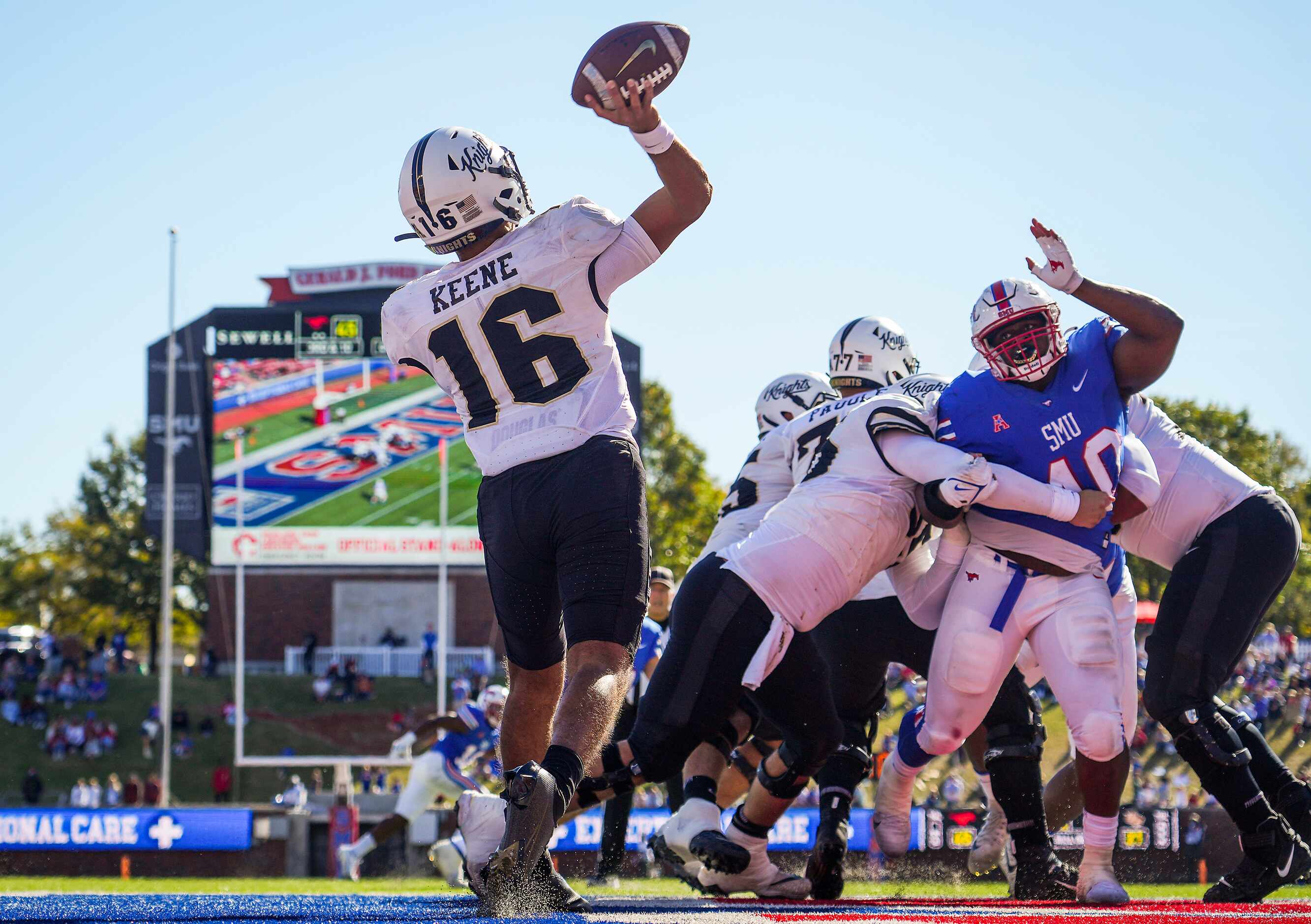 UCF quarterback Mikey Keene (16) throws a pass from his own end zone as SMU defensive tackle...