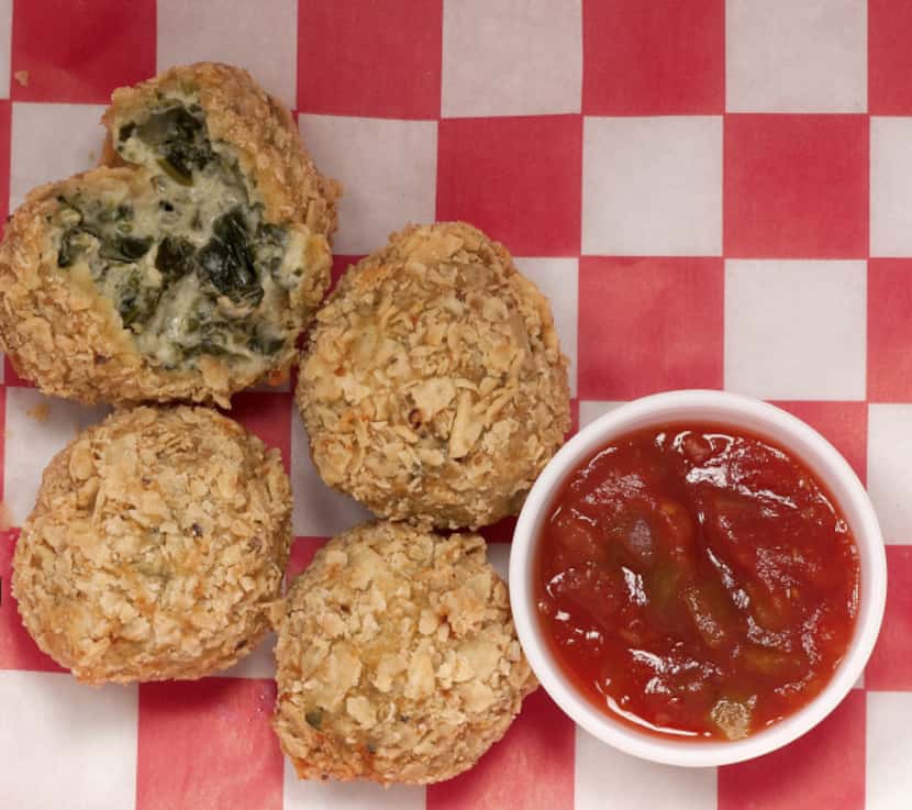Spinach Dip Bites are coated with tortilla chips and served with salsa.