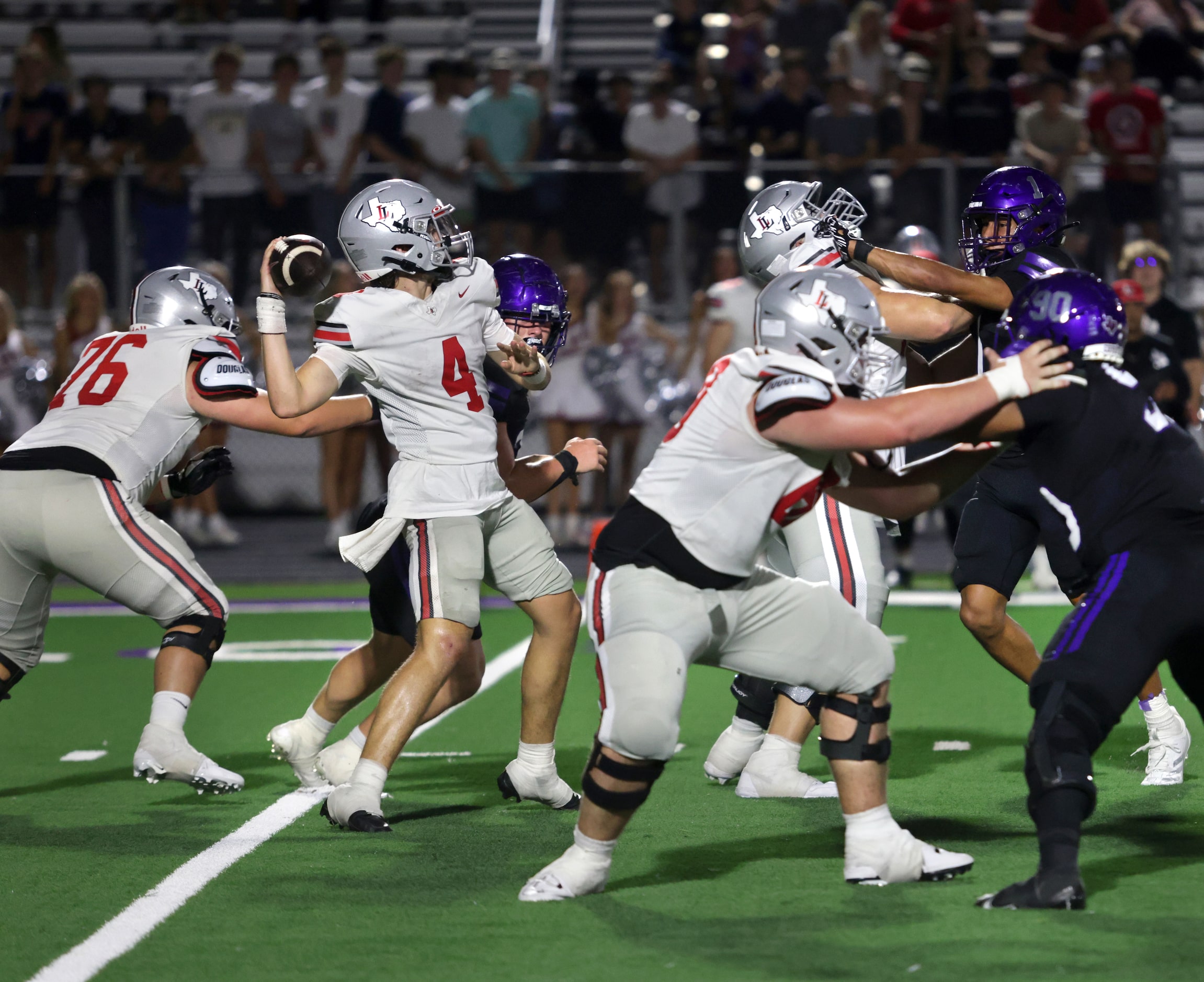 Lovejoy player #4 Jacob Janecek looks for an open receiver during the  Lovejoy High School...