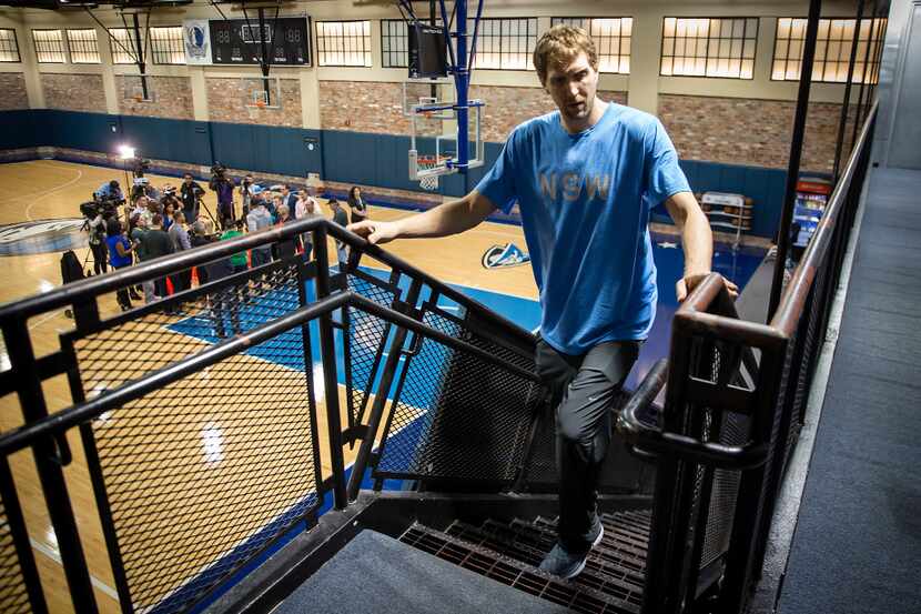 Dallas Mavericks forward Dirk Nowitzki leaves the floor while forward Harrison Barnes takes...