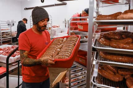 Sausage manager Mark McCourt transports a batch of sausage at the Original Roy Hutchins...