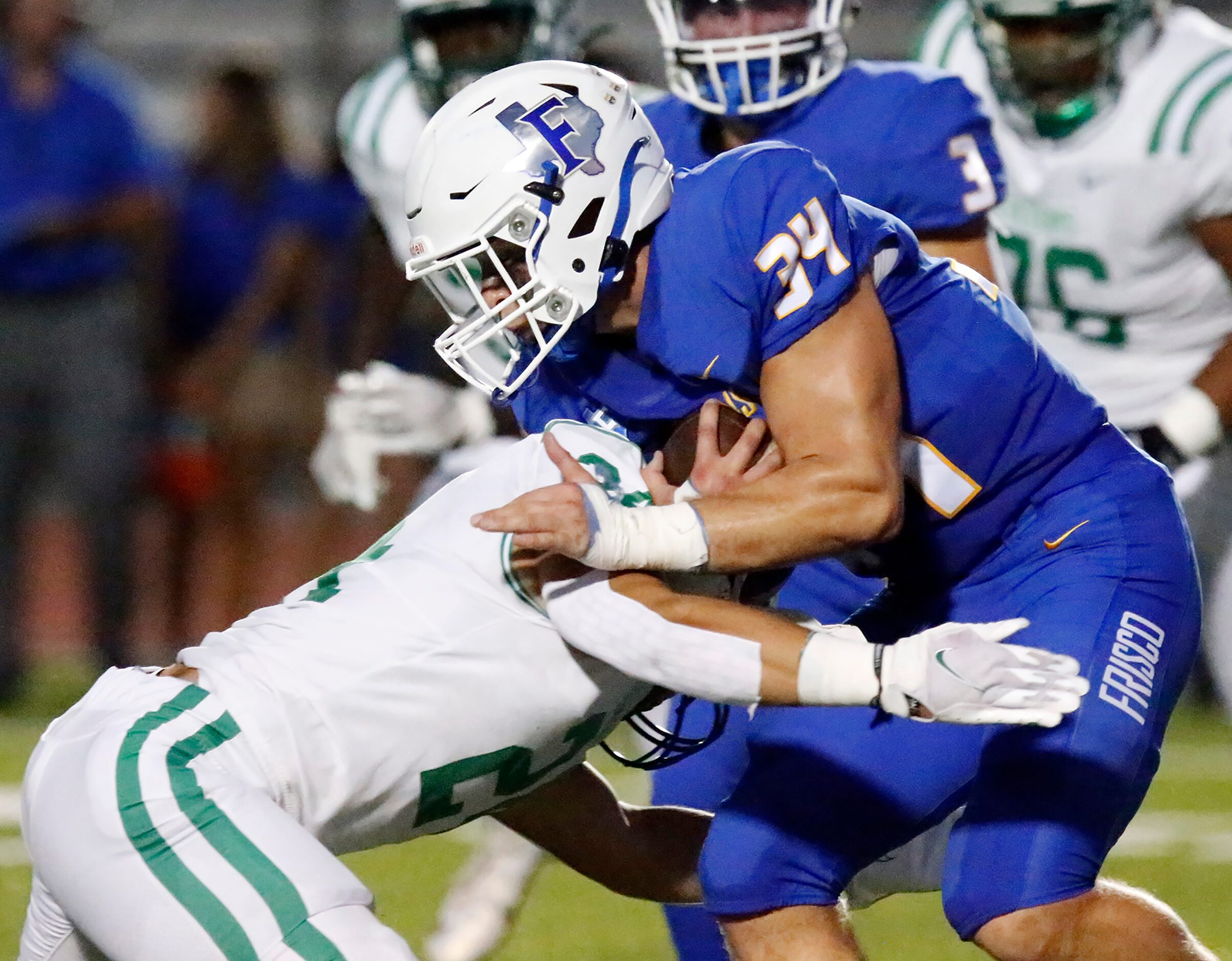 Lake Dallas High School middle linebacker Riley Griffin (24) stops Frisco High School Aj...