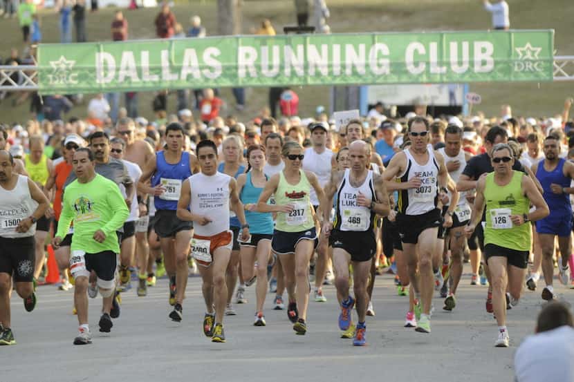 Runners begin the Dallas Running Club Half Marathon at White Rock Lake in Dallas on Sunday,...
