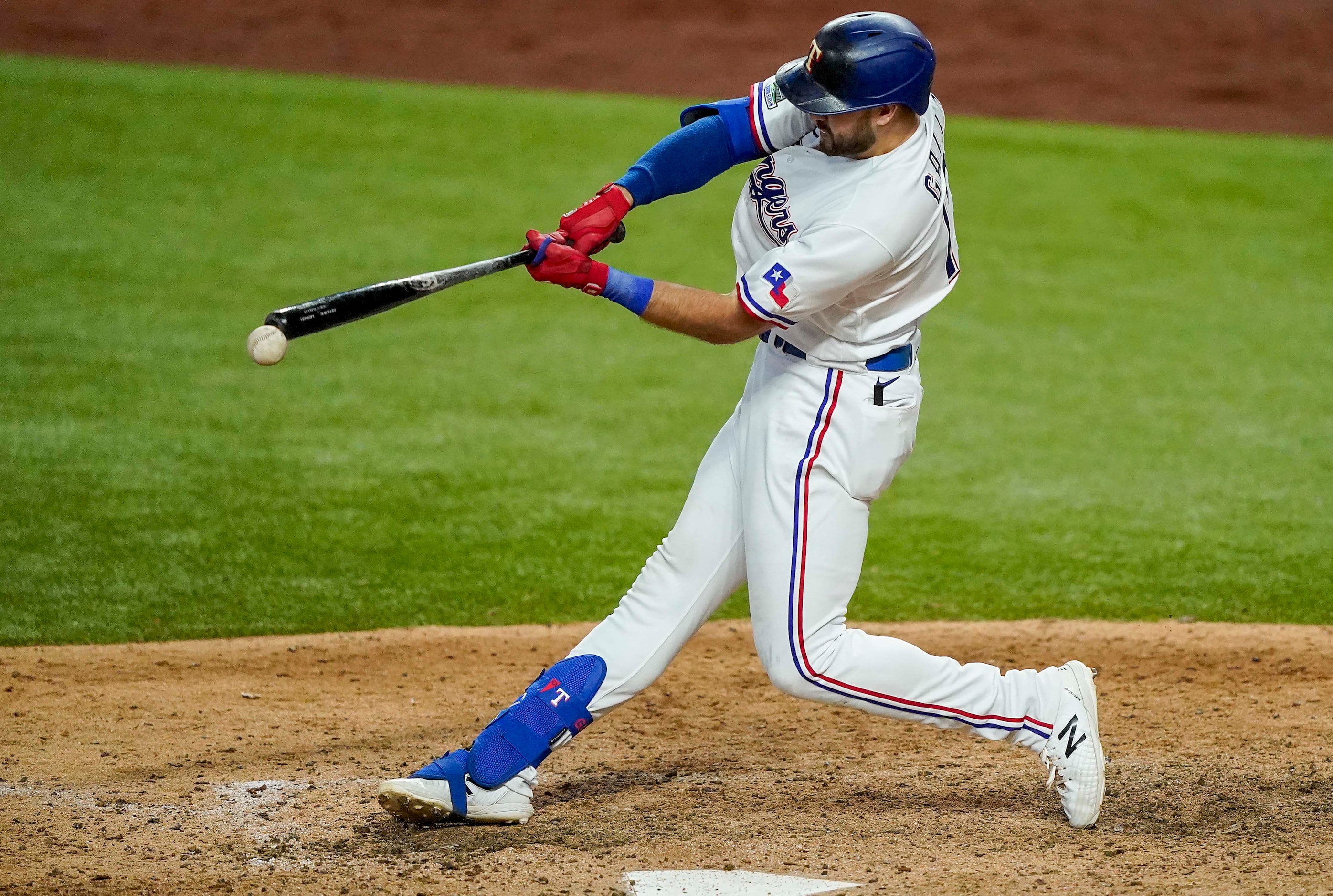 Texas Rangers outfielder Joey Gallo drives in a run with a single off the end of his bat...