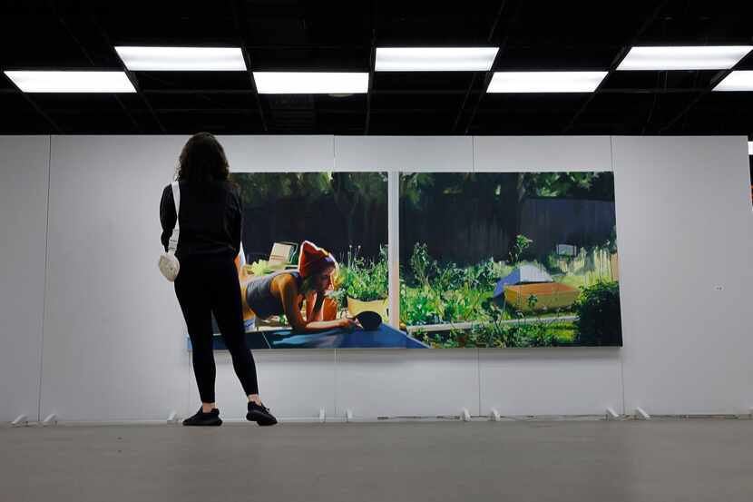 Chelsea Garcia of Dallas looks at a work by Ariel Davis during Vignette Art Fair at Dallas...