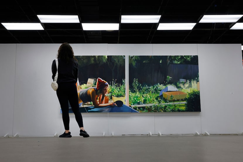 Chelsea Garcia of Dallas looks at a work by Ariel Davis during Vignette Art Fair at Dallas...