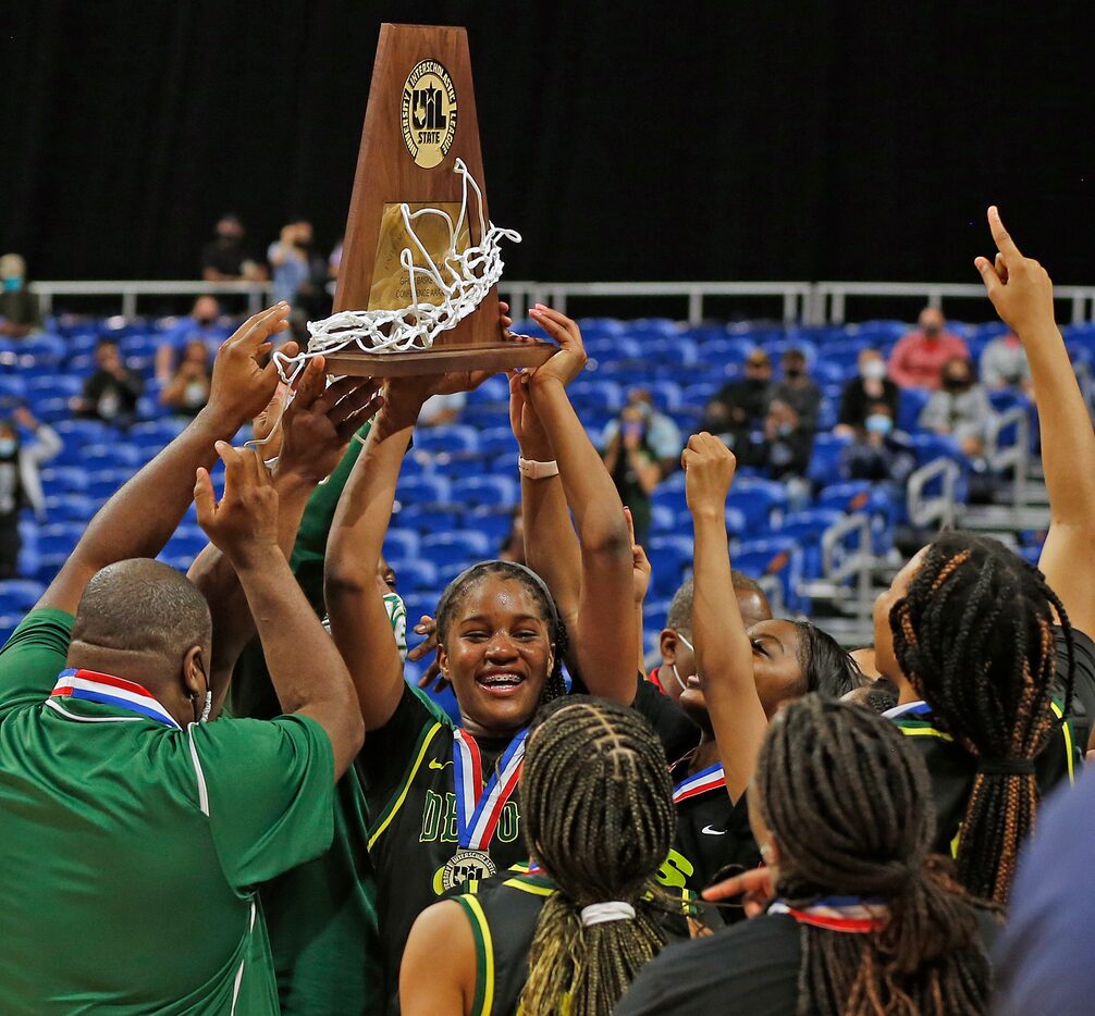 DeSoto Ayanna Thompson #20 holds up their trophy. DeSoto vs. Cypress Creek girls basketball...