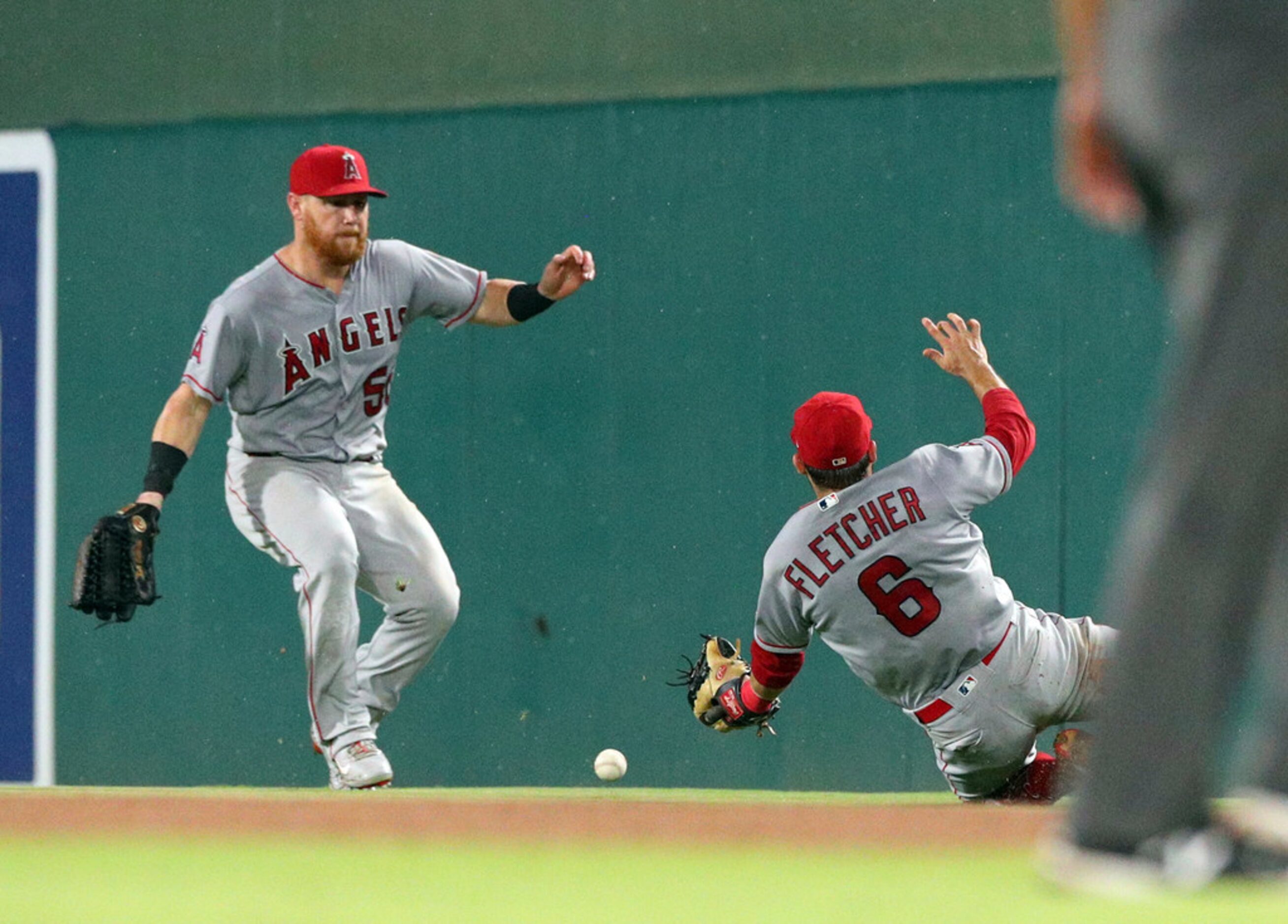 A fly ball by Texas Rangers' Adrian Beltre drops between Los Angeles Angels right fielder...