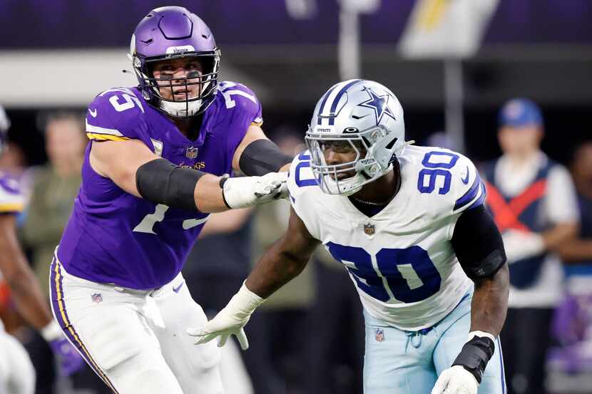 Minnesota Vikings offensive tackle Brian O'Neill (75) pushes Dallas Cowboys defensive end...