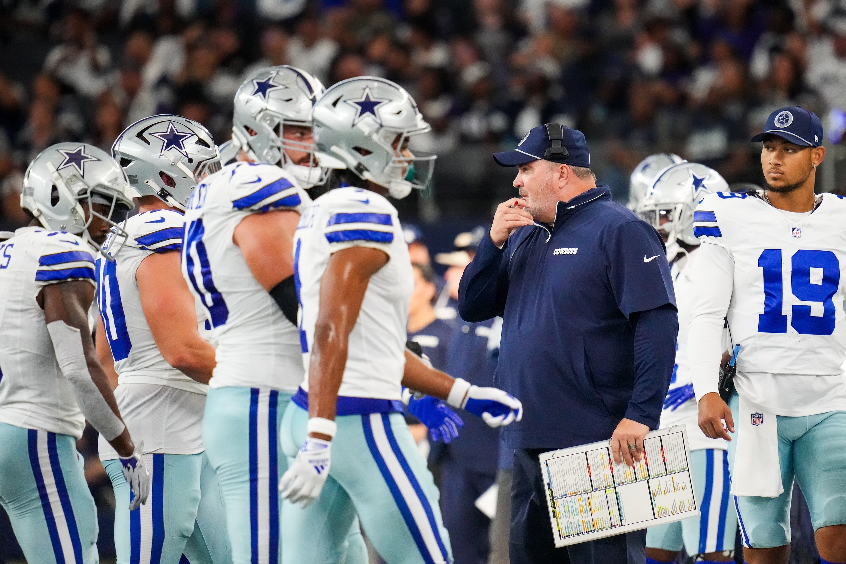 Dallas Cowboys head coach Mike McCarthy and quarterback Trey Lance (19) look on as the...