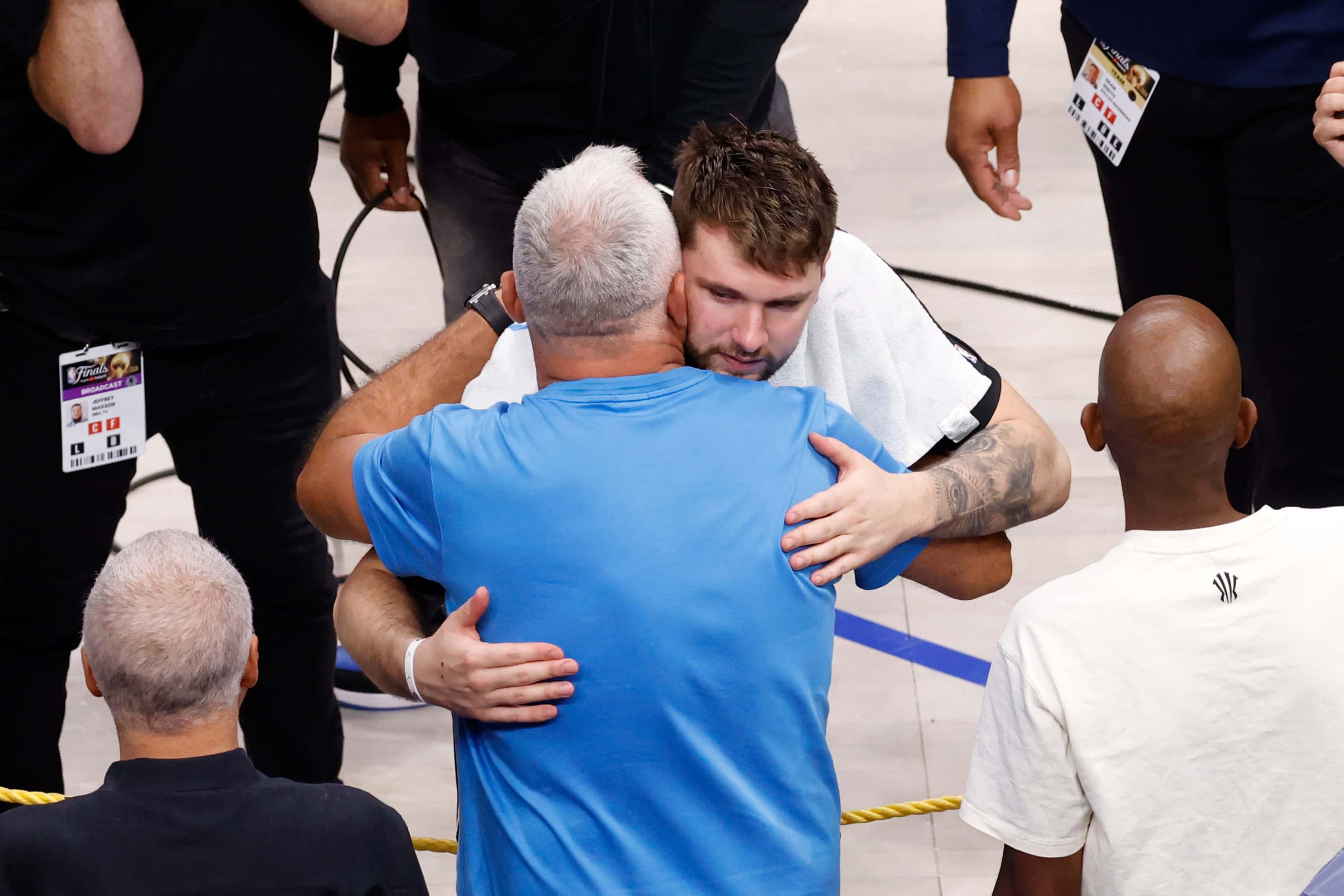 Dallas Mavericks guard Luka Doncic hugs his father Saša Doncic after Game 4 of the NBA...