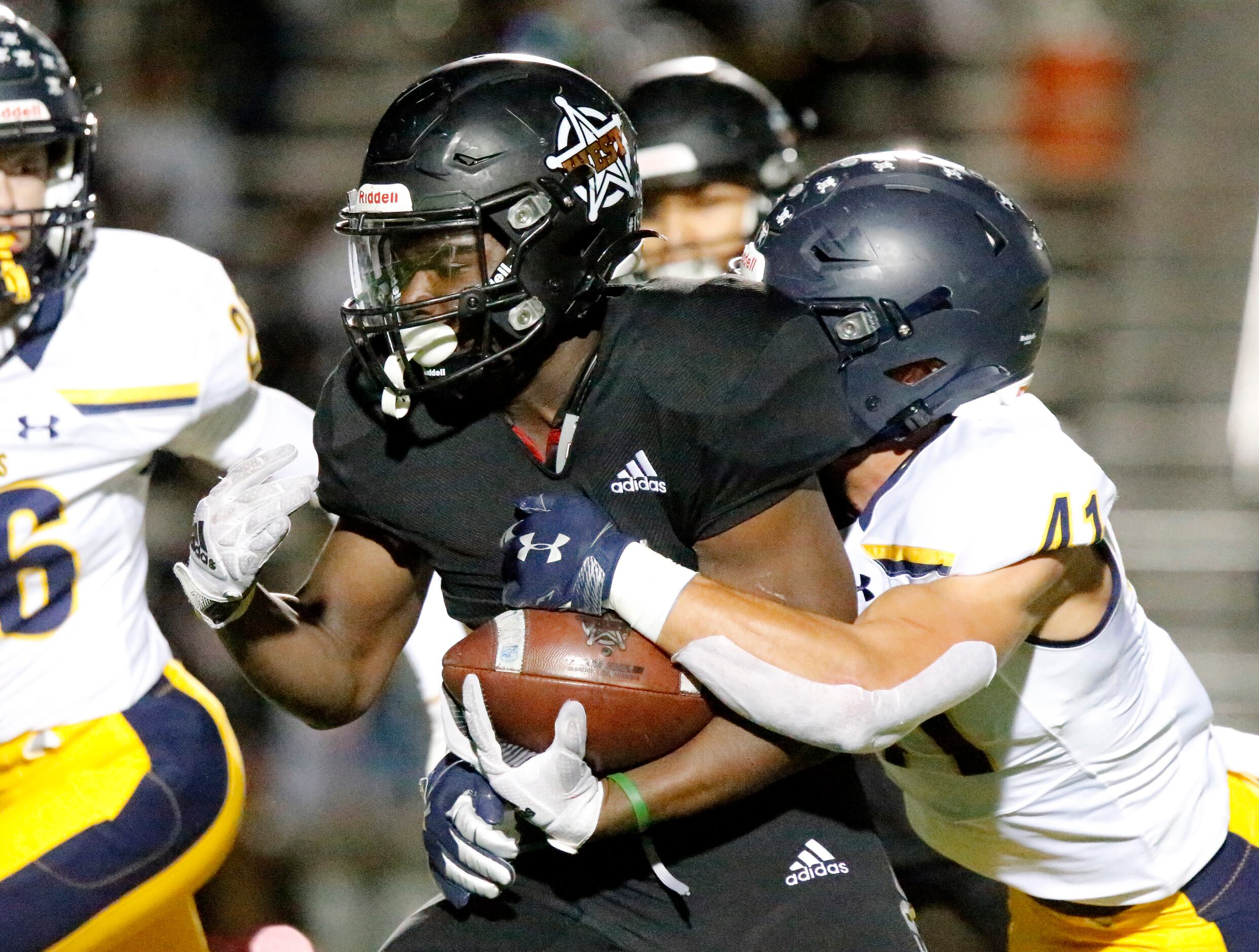 West Mesquite High School running back Canaan Dirden (16) is tackled by Highland Park High...
