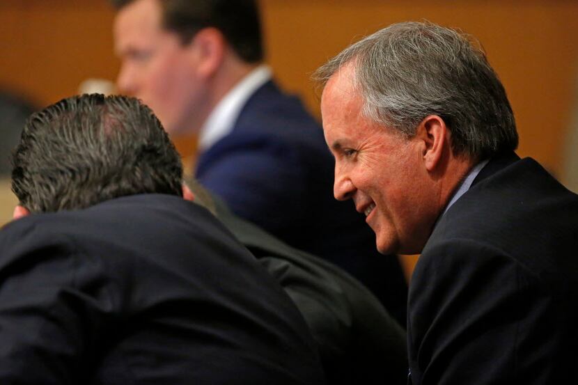 Texas Attorney General Ken Paxton smiles during his pretrial hearing at Collin County...