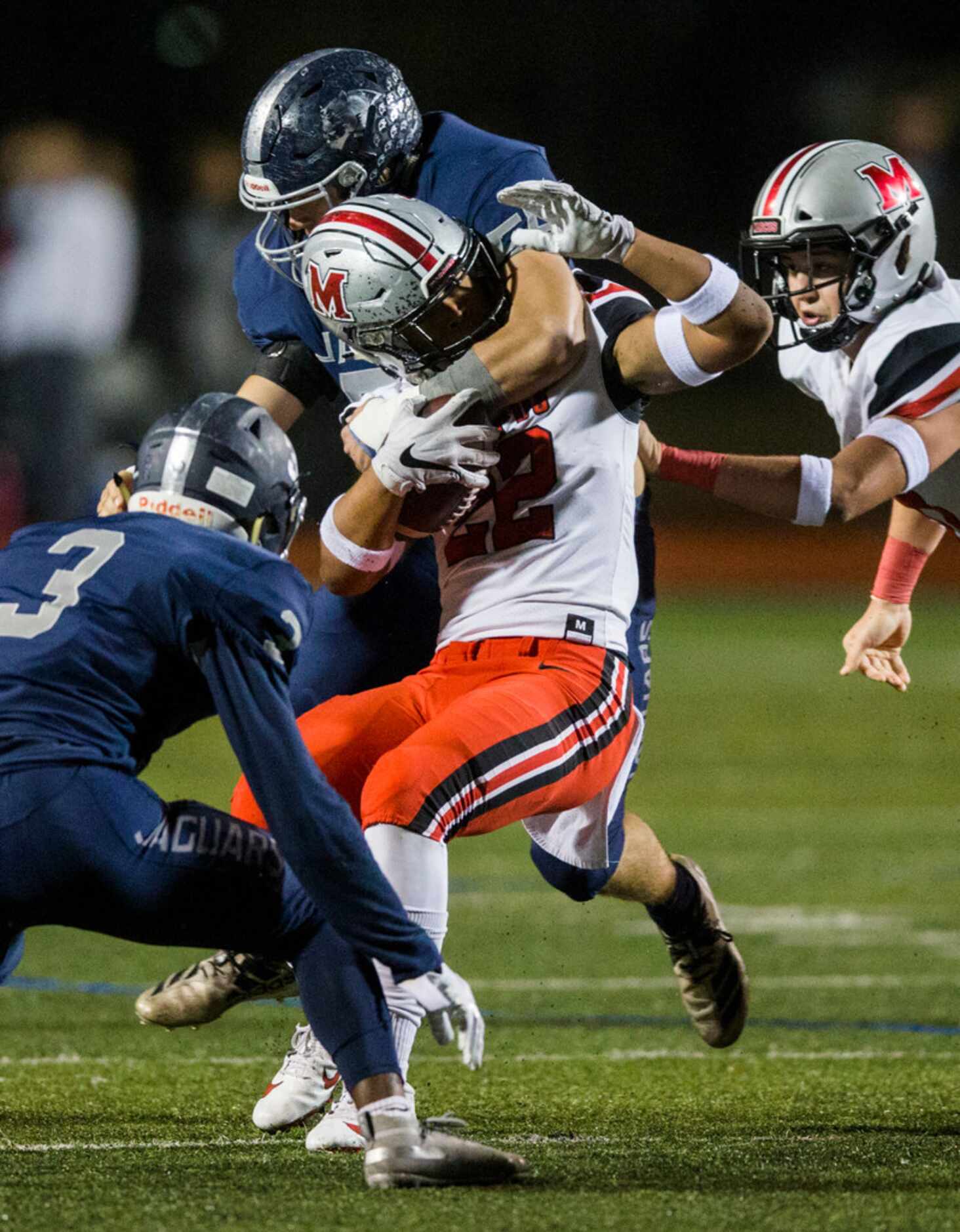 Flower Mound Marcus running back Ty'son Edwards (22) is tackled by Flower Mound defensive...