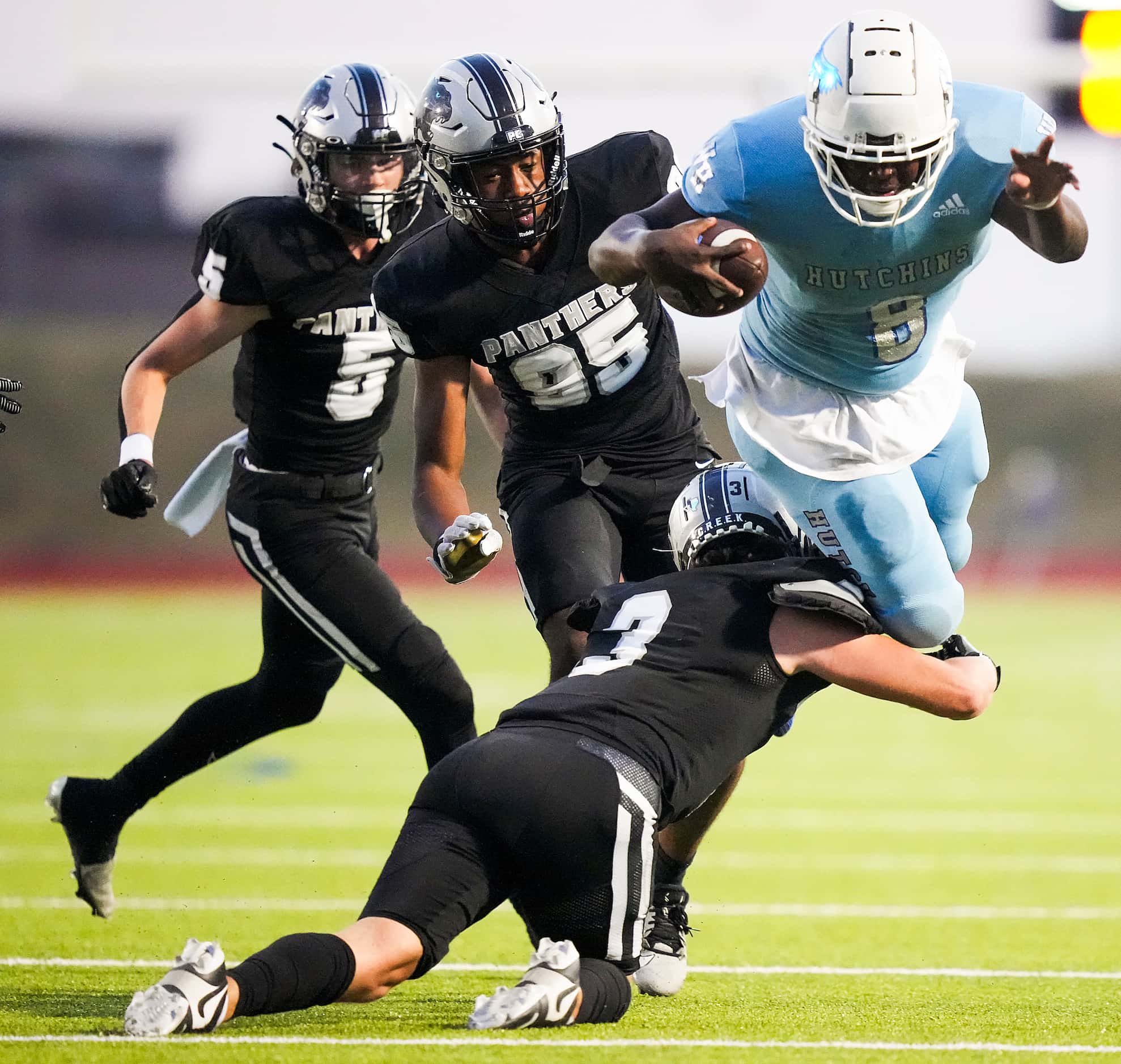 Wilmer-Hutchins running back Jacob Cummings (8) is brought down by Panther Creek’s Seth...