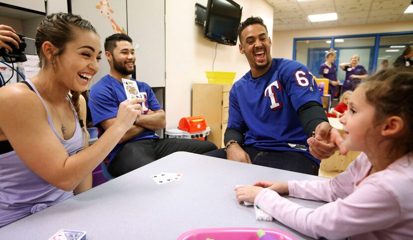 Kristen Davis (left) laughs with her daughter Charlee Davis, 7, after Texas Rangers' Ronald...