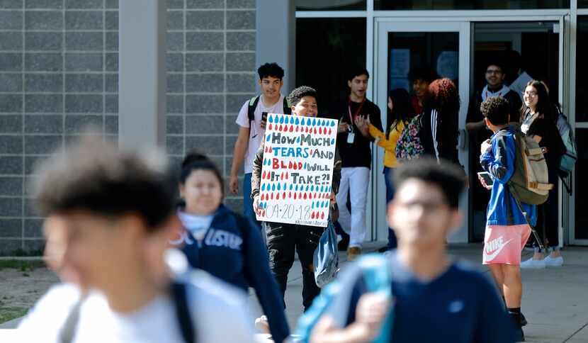 At MacArthur High in Irving, sophomore Damien Miles held a sign reading, "How much tears and...