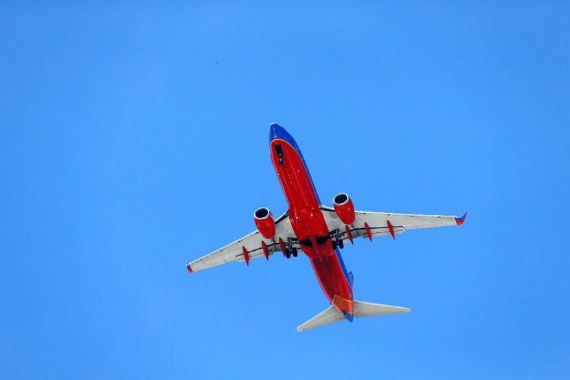 A Southwest Airlines jet makes it's approach to Dallas Love Field as it passes over...