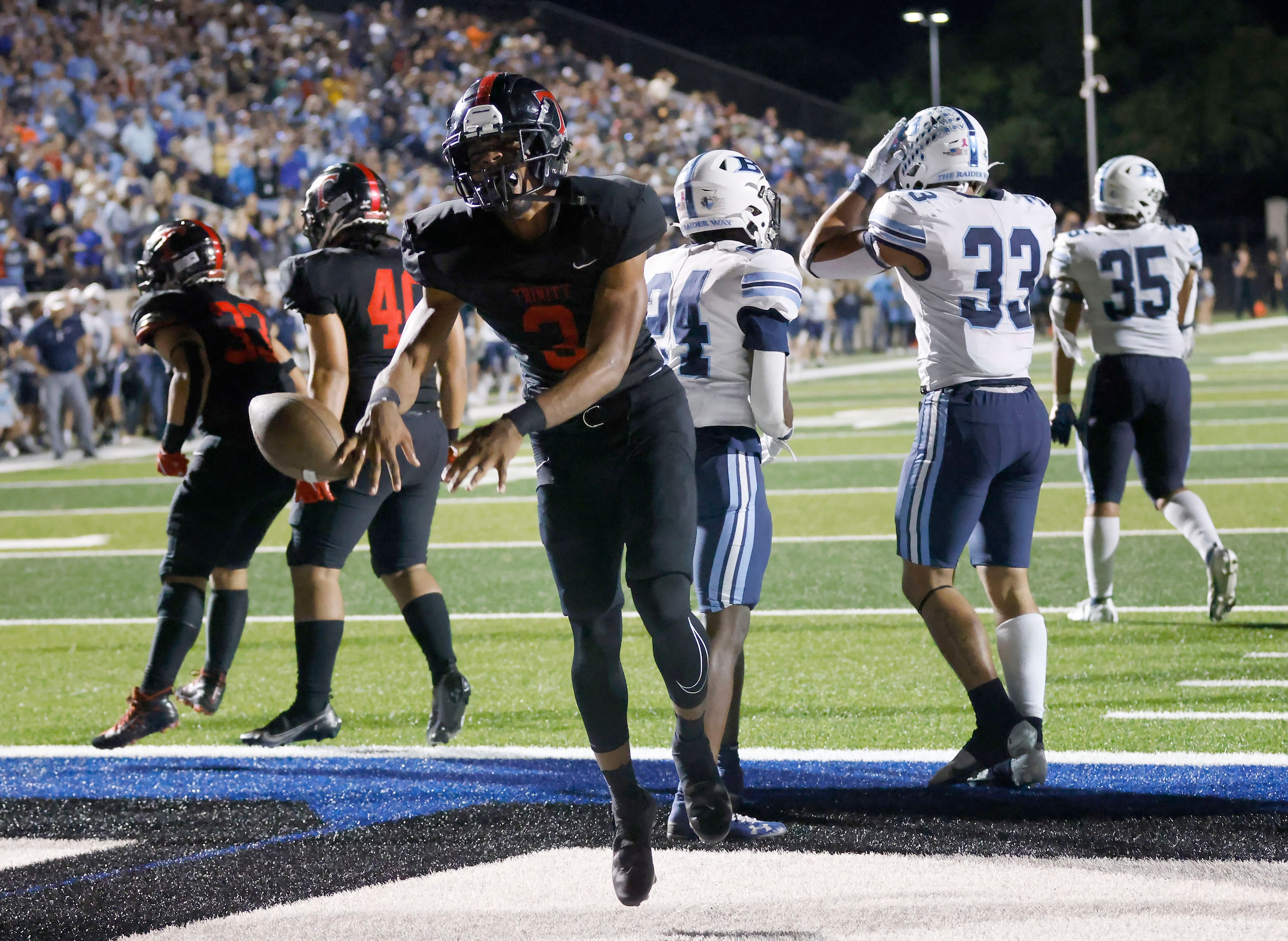 Euless Trinity running back Gary Maddox (3) celebrates after scoring the winning touchdown...