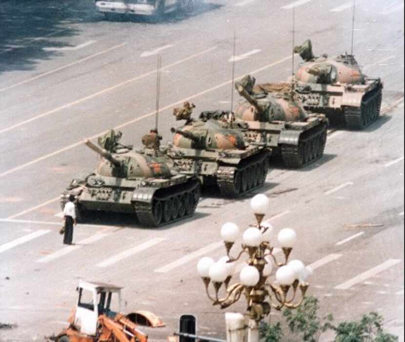 A Chinese man stands in front of a line of tanks in Beijing stopping their advance down...